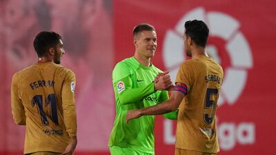 Marc-Andre ter Stegen celebrates victory with Sergio Busquets and Ferran Torres. Getty