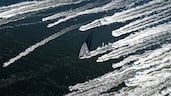 Comanche is escorted by spectator boats as it crosses the finish line in Hobart to win the Sydney to Hobart yacht race. AP