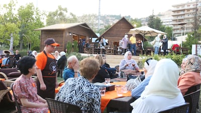 People order from a waiter at the restaurant. It employs people with Down syndrome to help them integrate into society. EPA