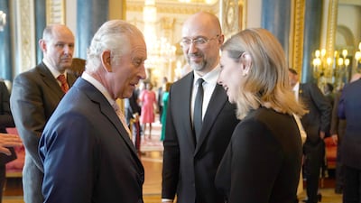 Britain's King Charles III, left, speaks to the First Lady of Ukraine Olena Zelenska and the Prime Minister of Ukraine, Denys Shmyhal, during the reception. AP