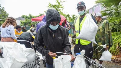 People pick up sandbags at a city run sandbag distribution location in New Orleans as residents prepare for Hurricane Ida. AP