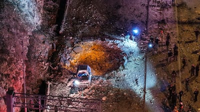 Israeli emergency responders at the scene of an Iranian missile strike on a road in Jerusalem. Reuters