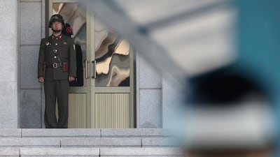 A North Korean soldier, left, looks at the South side as a South Korean soldier, right, stands guard at the truce village of Panmunjom in the Demilitarized Zone which has separated the two Koreas since the Korean War, in Paju, South Korea, Thursday, Sept. 28, 2017.