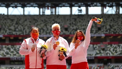 Women's hammer gold medalist Anita Wlodarczyk of Poland, silver medalist Wang Zheng of China and bronze medalist Malwina Kopron of Poland celebrate on the podium.