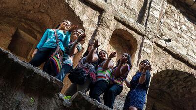 A group of girls pose for pictures at the Agrasen ki Baoli in New Delhi.