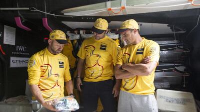 New Zealand rugby players Richie McCaw, centre, and Dan Carter, right, talk with Abu Dhabi Ocean Racing skipper Ian Walker aboard Azzam. Photo Courtesy / Ian Roman / Abu Dhabi Ocean Racing