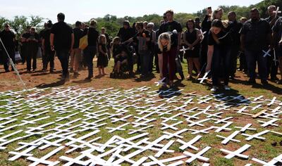 People place white crosses, representing farmers killed in the country, at a ceremony at the Vorrtrekker Monument in Pretoria, South Africa, in 2017. AP