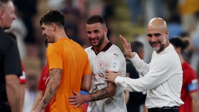 Manchester City manager Pep Guardiola and Kyle Walker celebrate their victory over Urawa Red Diamonds in the Club World Cup semi-final in Jeddah. Reuters