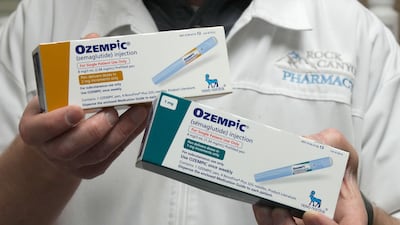 A pharmacist displays boxes of Ozempic, a drug used for treating Type 2 diabetes. Reuters