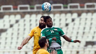 Iraq's Amjed Kalaf, right, challenges Australia captain Mile Jedinak during the 2018 World Cup qualifying Group B contest. The match ended 1-1. Abedin Taherkenareh / AFP
