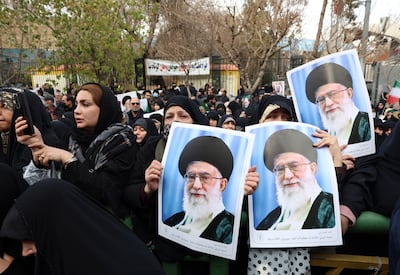 Mourners hold portraits of Iranian supreme leader Ayatollah Ali Khamenei during funerals in Tehran. EPA
