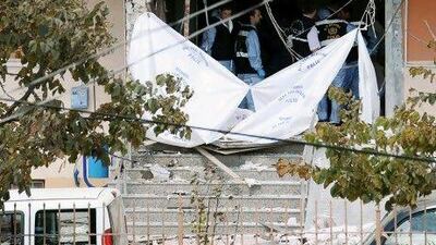 Forensic investigators seal off the entrance of police station in Istanbul, Turkey, where a suicide bomber threw a hand grenade and blew himself up.