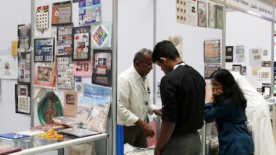 Visitors look at the vintage stamps and bank notes on display on November 11, 2016, at the stamp exhibition in Mega Mall in Sharjah. Pawan Singh / The National
