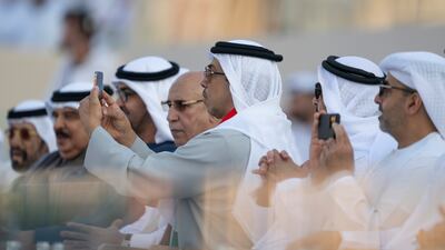 Sheikh Mansour bin Zayed, Vice President, Deputy Prime Minister and Chairman of the Presidential Court, takes a photograph of proceedings. Abdulla Al Neyadi / Presidential Court