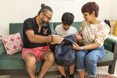 The Dubai family search through a bag containing belongings long thought to have been lost for good. Antonie Robertson / The National