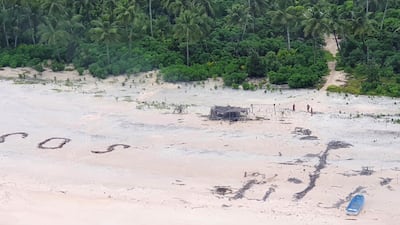 An Australian Army helicopter lands on Pikelot Island where three men were found safe and healthy after their giant SOS sign was spotted by warplanes. Australian Defence Force via AFP