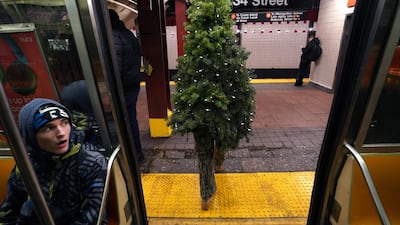 Sreet performer Thomas Liberto from Bel Air, Maryland, who goes by the social media name "Mr Christmas Tree" takes the subway around midtown New York. AFP