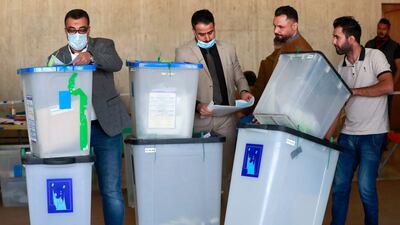 Employees of Iraq's Independent High Electoral Commission conduct a partial manual recount of votes for the October 10 elections, in Baghdad on November 23. AFP