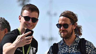 Aston Martin's German driver Sebastian Vettel poses for a selfie with a fan. AFP