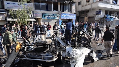 Emergency services and civilians gather at the site of a car bomb explosion in a predominantly pro-government neighbourhood of the central Syrian city of Homs on December 5, 2107. AFP