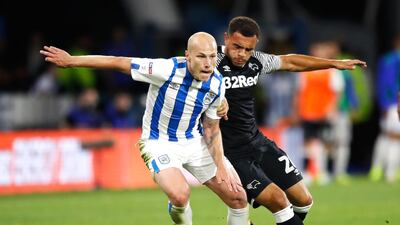 Aaron Mooy, left, is staying in the Premier League after joining Brighton and Hove Albion from relegated Huddersfield Town. PA Photo