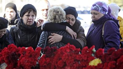 A small crowd, some of them relatives and friends of the victims of the crashed plane, comfort one another at the Rostov-on-Don airport. All 62 people aboard the flight from Dubai were killed in the crash. AP Photo