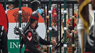 A Pakistani Ranger (left) and a member of the Indian Border Security Force (BSF) at the Wagah border post near Lahore. AFP