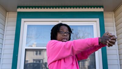 Briana Tyler demonstrates the gunman shooting indiscriminately, as she talks about witnessing the mass shooting at a Walmart. AP