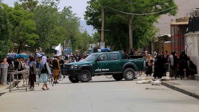 Taliban stand guard in an area surrounding a school in the aftermath of multiple bomb blasts in a Shi'ite majority neighborhood, in Kabul, Afghanistan. EPA