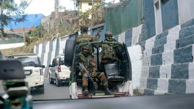 Indian soldiers travel in a convoy in Kohima, capital of Nagaland state, on Sunday. Angry villagers burnt army vehicles in protest in the state after a group of miners were killed by soldiers, who mistakenly believed they were militants. Photo: AP