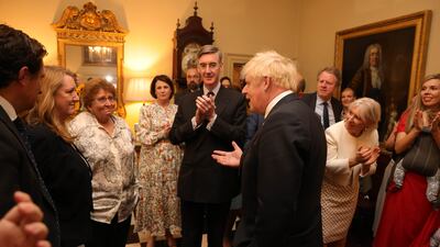 Staff members rally round Mr Johnson after his speech.