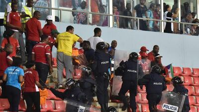 Policemen evacuate a tribune during the 2015 African Cup of Nations semi-final football match between Equatorial Guinea and Ghana in Malabo, on February 5, 2015. Play was halted eight minutes from time in the Africa Cup of Nations semi-final between hosts Equatorial Guinea and Ghana when missiles were thrown on the pitch. AFP PHOTO / ISSOUF SANOGO