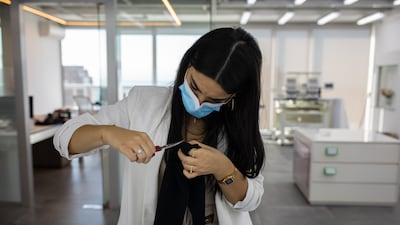 Stephanie Rizk carries out some quality control on a pair of trousers.