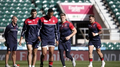 England's Owen Farrell, second right, and teammates put in a jog during their Friday training session ahead of Saturday's match against Wales in Rugby World Cup pool play. Adrian Dennis / AFP