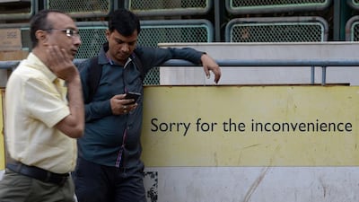 An Indian onlooker checking his mobile phone. The country has 200 million active WhatsApp users, and at least 300 million Indians use smartphones that support the popular messaging service and more than a billion people own mobile phones that support basic text messaging. Indranil Mukherjee/AFP Photo