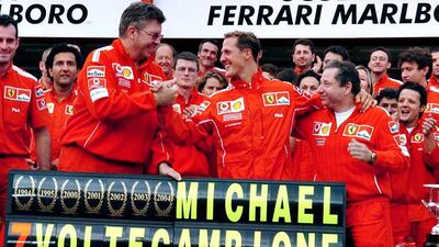 Michael Schumacher, centre, was in dominant form in 2004 as he won a record 13 races and collected the last of his seven world titles. Oliver Weiken / EPA
