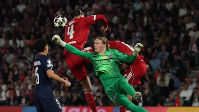 Paris Saint-Germain's Russian goalkeeper Matvey Safonov makes a save in front of Liverpool's Dutch defender Virgil van Dijk during the UEFA Champions League quarter-final first leg football match in Paris. AFP