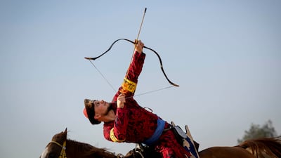 Baris Demirtas demonstrates the Kabak, in which a target is hung high to simulate shooting up the walls of a castle
