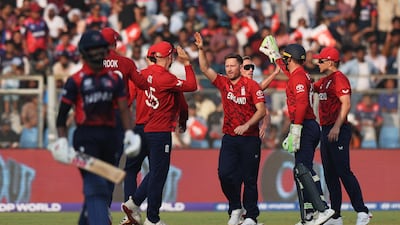 England's Liam Dawson celebrates with teammates after taking the wicket of Nepal batter Aasif Sheikh for seven. Reuters