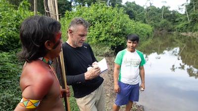 Veteran foreign correspondent Dom Phillips, centre, in Aldeia Maloca Papiú, in Roraima state, Brazil. AFP