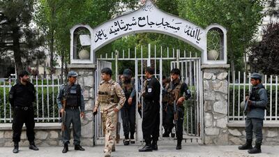 Afghan policemen inspect at the gate of a mosque after a blast in Kabul, Afghanistan, on June 12, 2020. Reuters