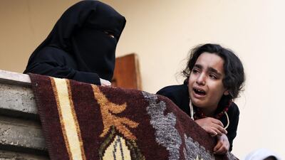 Relatives of a Palestinian militant from Hamas' Ezzedine Al Qassam Brigades, who was killed the previous day in an Israeli air strike, mourn during his funeral in Gaza City on December 9, 2017. Mahmud Hams / AFP