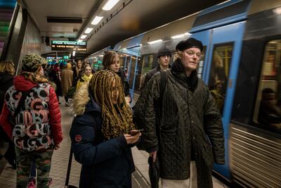 Passengers who are not wearing masks board a train in Stockholm on December 4 amid a surge in coronavirus cases. Getty Images
