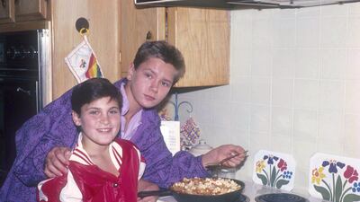 Joaquin and River Phoenix cooking at their home in Los Angeles, California, circa 1985. Photo: Dianna Whitley / Getty Images