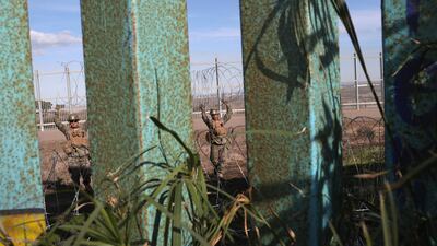 Marines continued reinforcing the fence on the San Diego side of the border, with thousands of members of the migrant caravan housed nearby in Tijuana. Getty Images