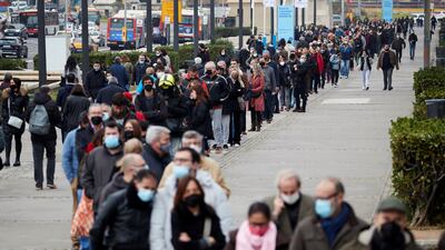 People queue to receive a dose of Covid-19 vaccine in Barcelona, Spain, on December 23. EPA