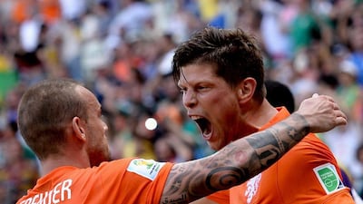 Wesley Sneijder, left, and Klaas Jan Huntelaar celebrate after Huntelaar's penalty winner in added time for a 2-1 victory over Mexico in the 2014 World Cup round of 16 on Sunday in Fortaleza, Brazil. Georgi Licovski / EPA / June 29, 2014