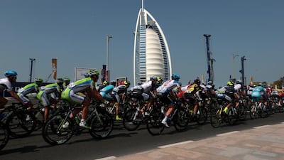 Cyclists ride by the Burj Al Arab during the fourth stage of the first staging of the Dubai Tour cycling race last year. Christopher Pike / The National / February 8, 2014