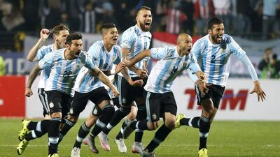 Argentina rush to celebrate with Carlos Tevez after his penalty sealed their passage into the Copa America semi-finals. Juan Carlos Cardenas / EPA June 26, 2015