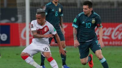 Peru's Christian Cueva, left, is challenged by Argentina's Lionel Messi. AFP